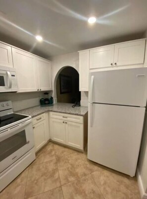 Enjoy cooking in this well-equipped kitchen with a microwave, stove, oven, and refrigerator.