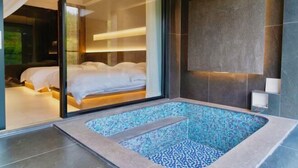 A modern bathroom with a glass-enclosed shower, a large bathtub with mosaic tiles, and a visible bedroom with a bed and curtains. - Retang Village Longfa Hot Spring Villa (Huidong)