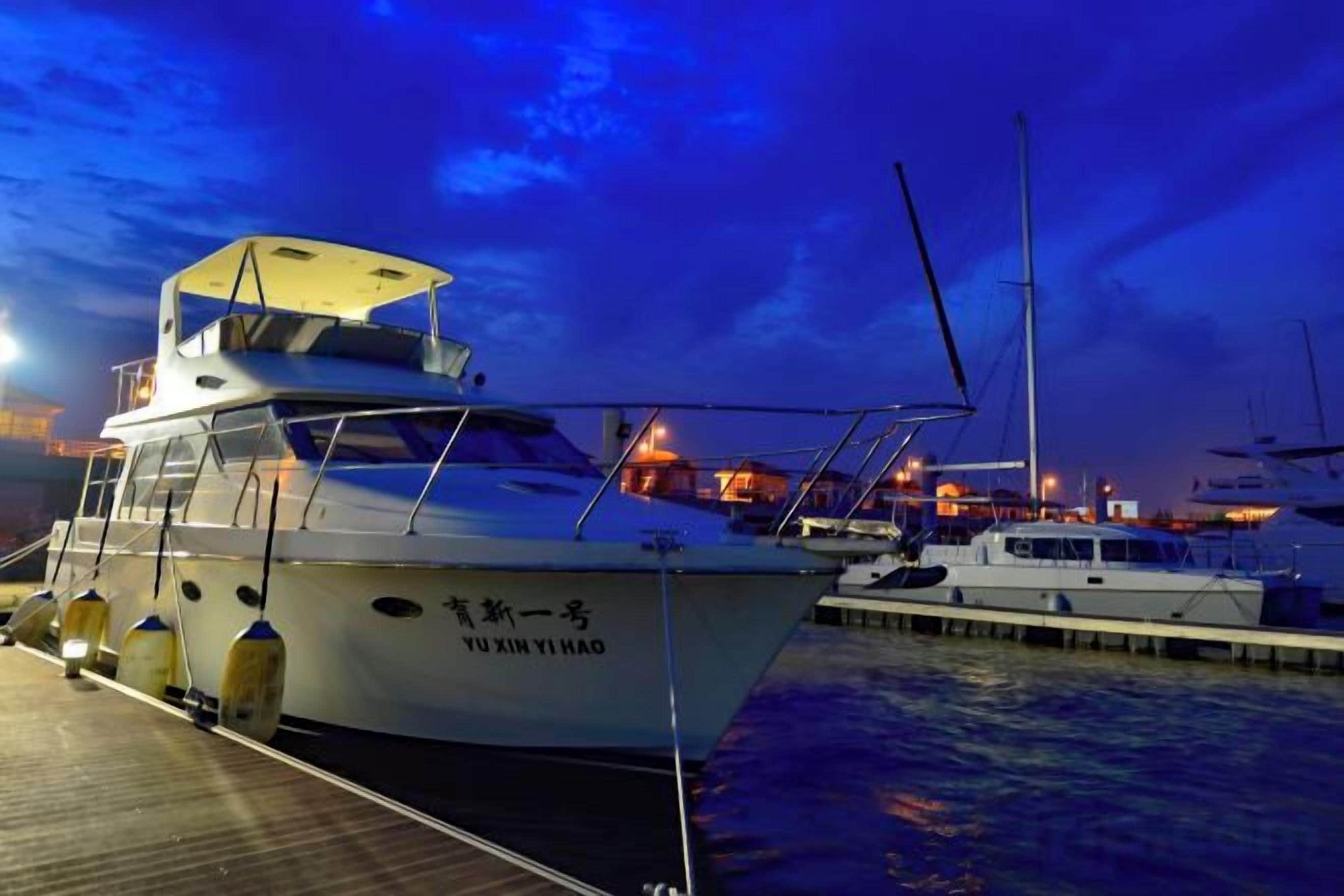 Un barco atracado en un puerto deportivo con cielo despejado.