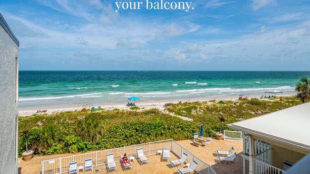 Ein Balkon mit Blick auf Strand und Meer.