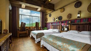 A room with two beds, a desk, a chair, and a large window. - Dating Inn (Pu'er)
