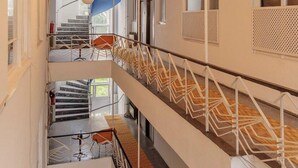 A multi-level interior with a staircase, railings, and hanging spherical light fixtures. - Petek Pansiyon (Istanbul)