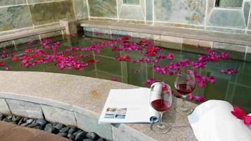 Relax by the serene pool, surrounded by a peaceful ambiance and a tranquil water feature.