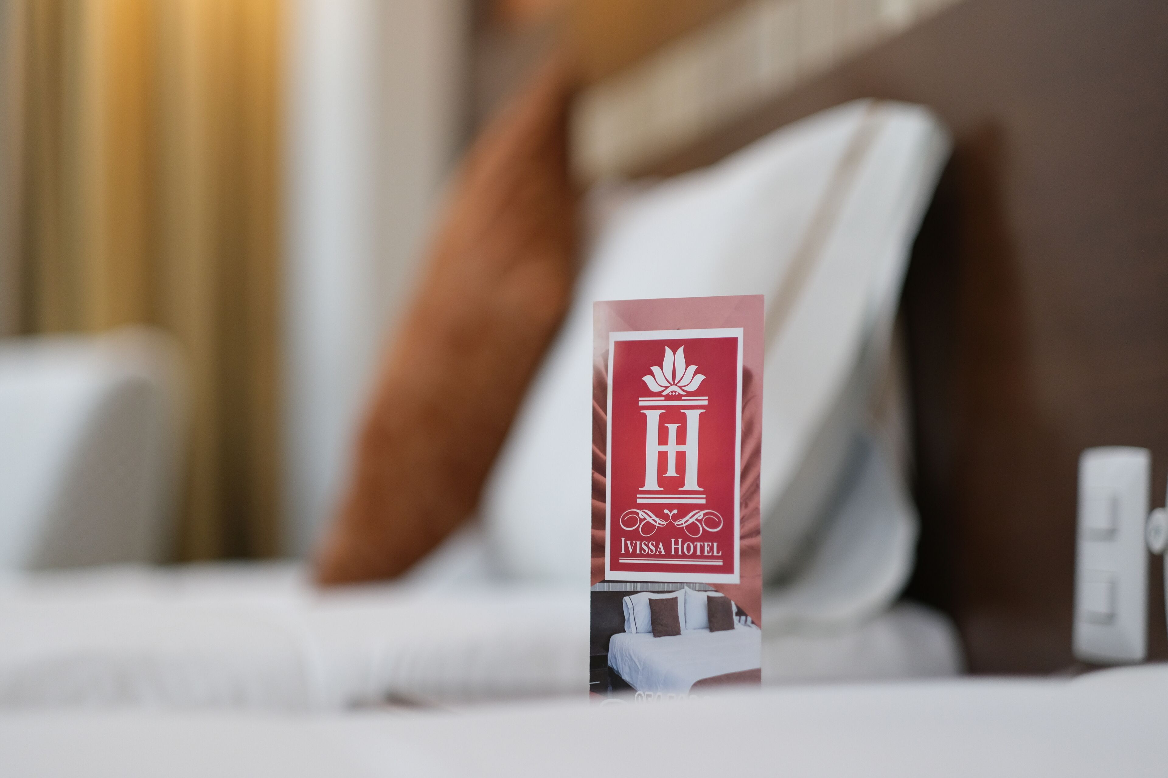 A hotel sign with the name "Ivissa Hotel" and a logo.