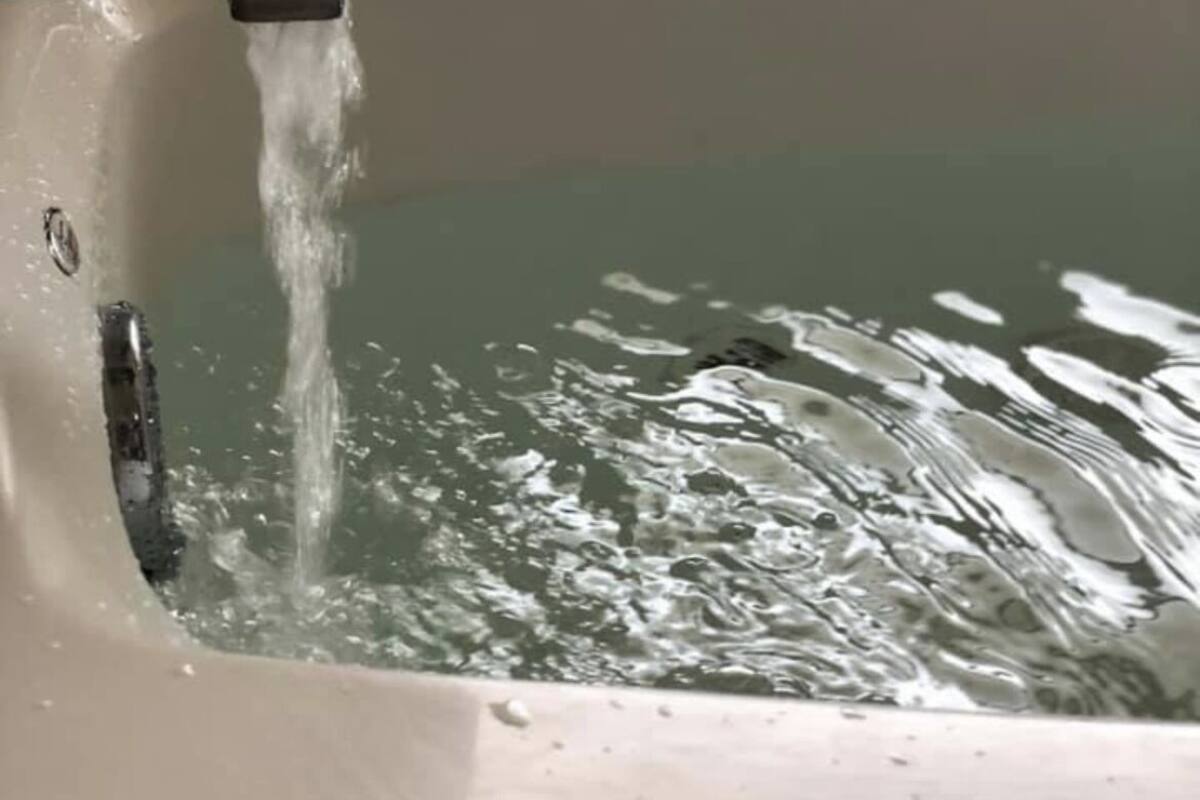 A bathtub with running water.