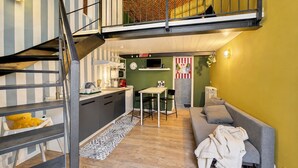 A compact living space with a kitchen, dining area, and a sofa.