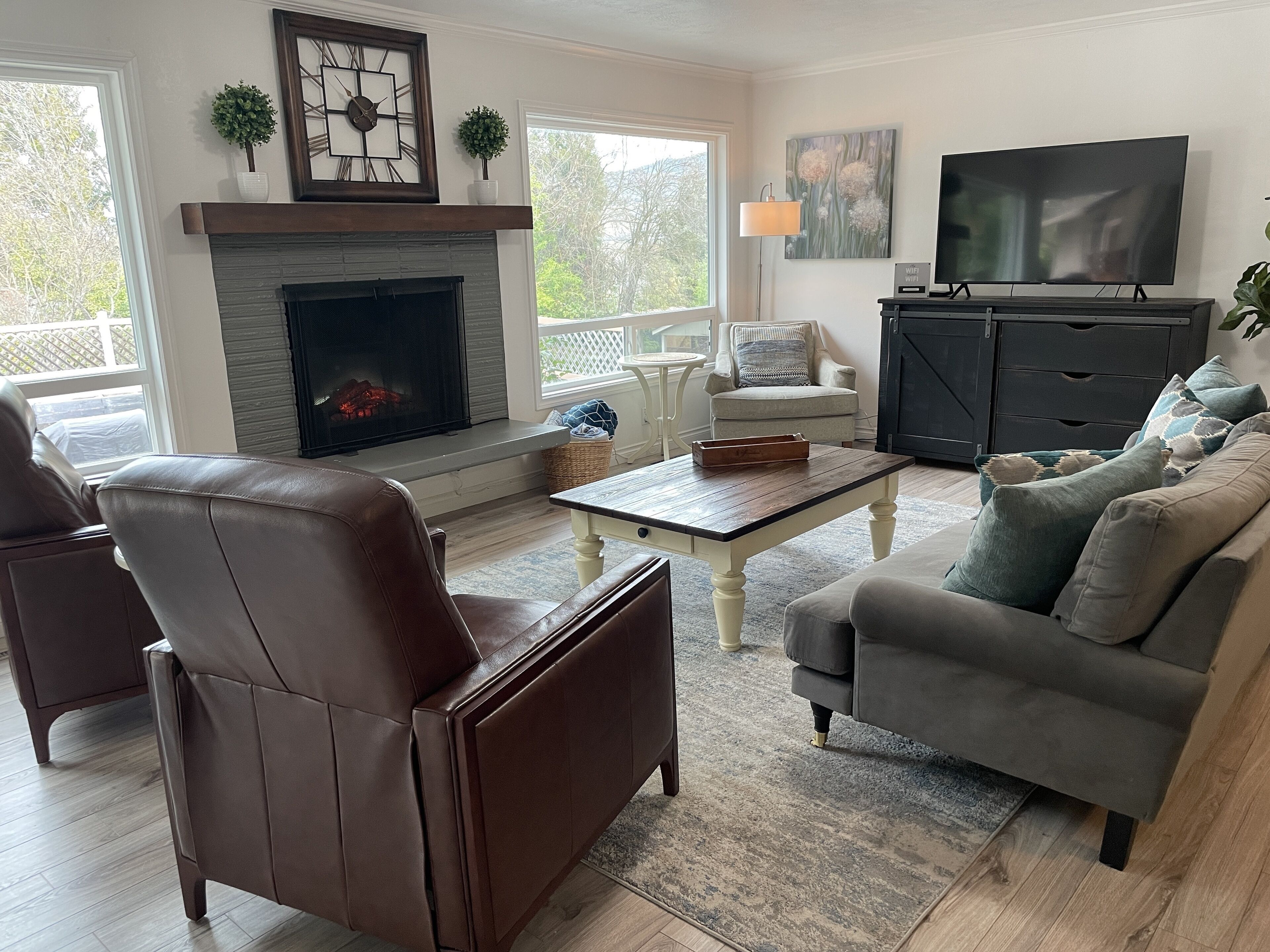 A living room with a fireplace, a television, and a comfortable seating area.
