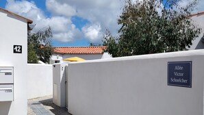 A gated residential area with a sign reading "Allée Victor Schoelcher."