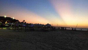 A beach with tents and a few people, suggesting a casual, possibly outdoor event or gathering. - Terraço Flecheiras (Trairi)