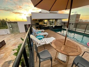 Una piscina al aire libre, una piscina climatizada, sombrillas