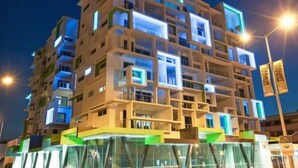 Een meerlaags gebouw met balkons en een glazen gevel.