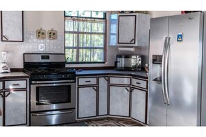 Fridge, cookware/dishes/utensils, dining tables