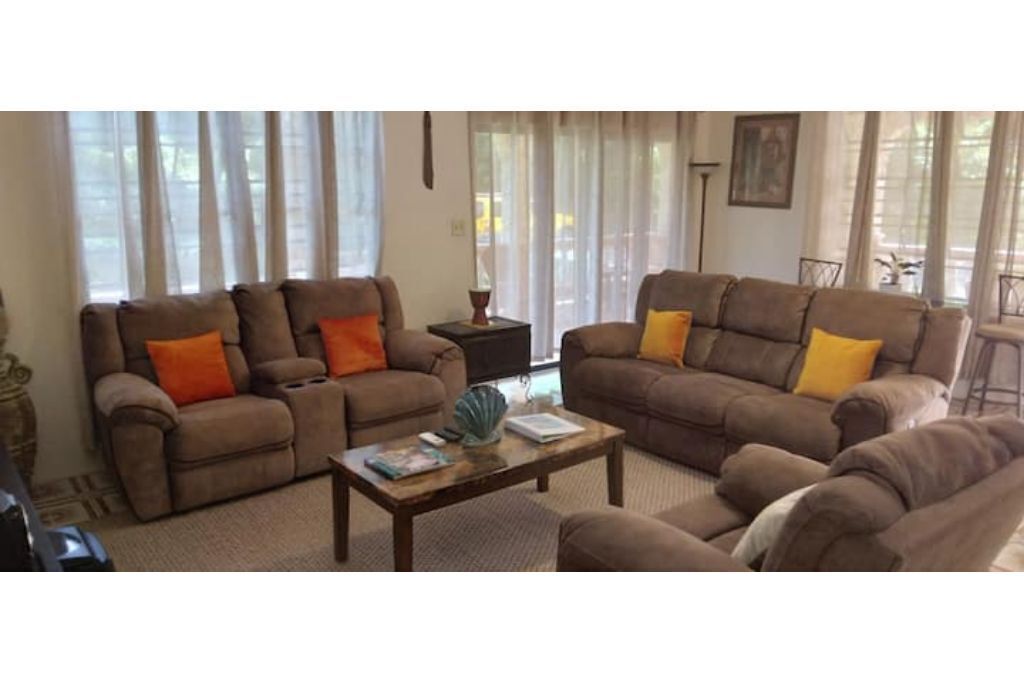 A living room with two sofas, a coffee table, and a side table.
