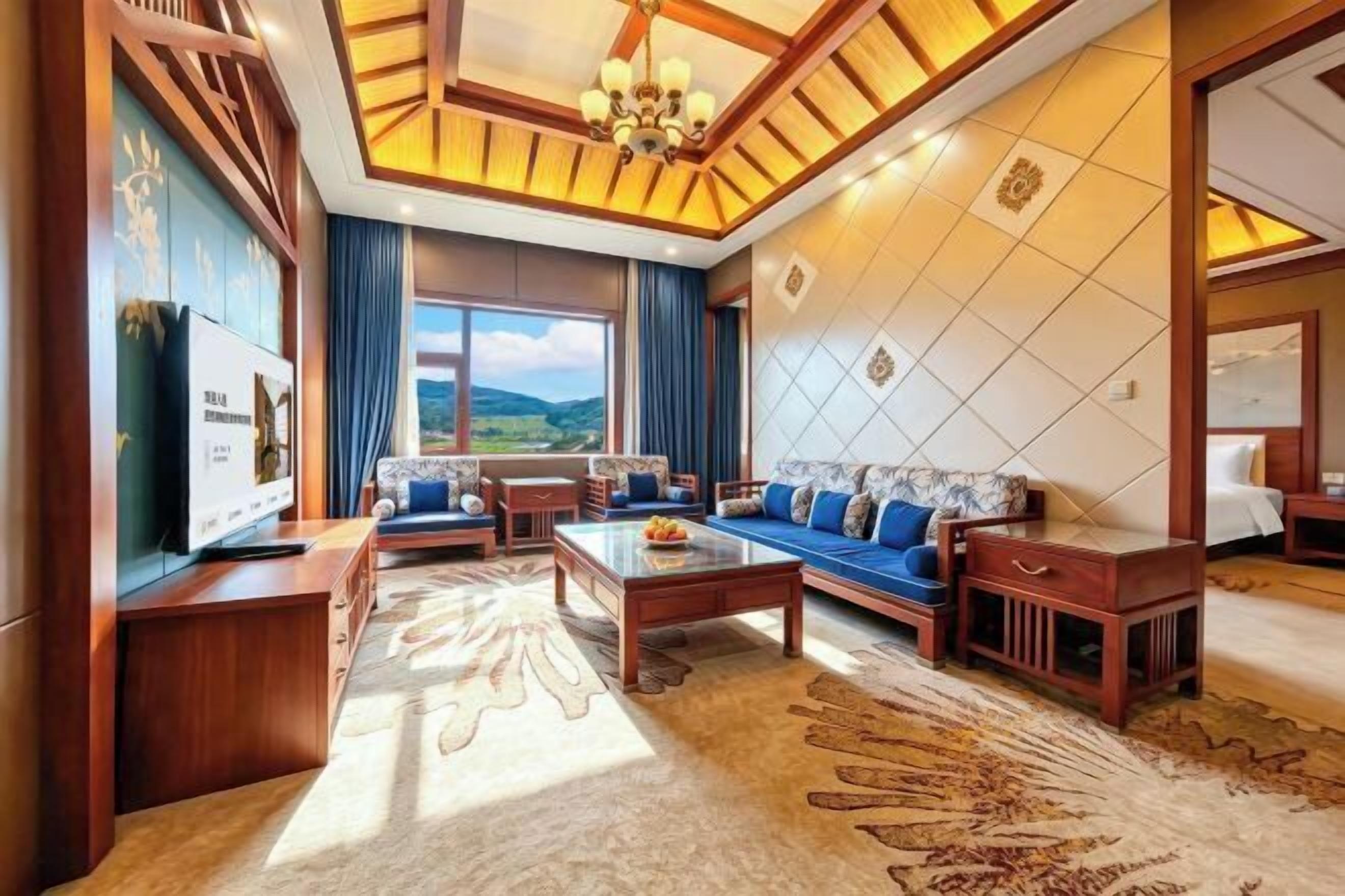 A spacious living room with a sofa set, a coffee table, and a television.