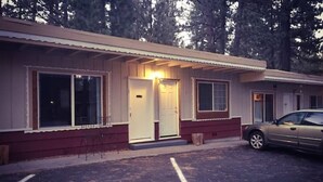 A single-story building with a front door, windows, and a parked car. - 01-The Cascade Falls studio at the Washoe (South Lake Tahoe)