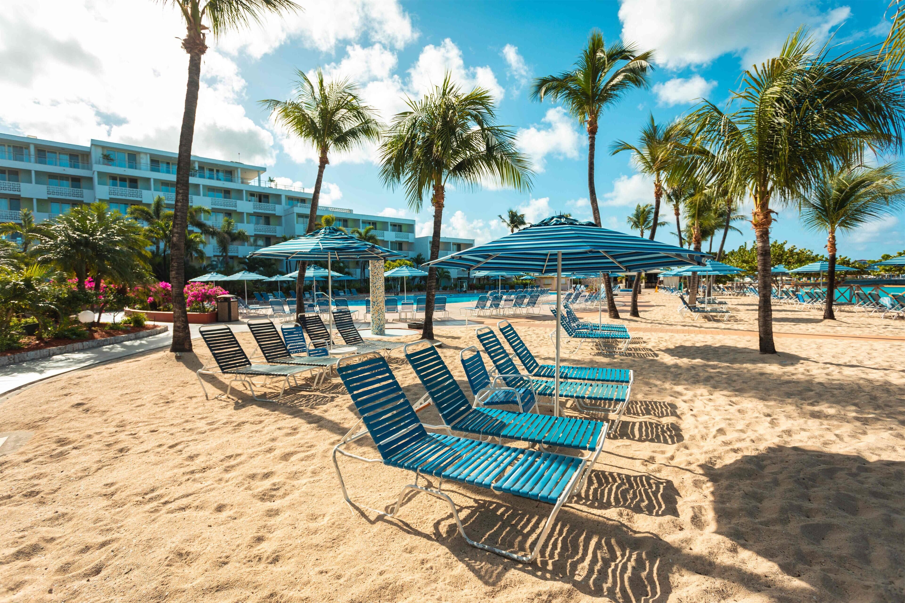 On the beach, white sand, sun-loungers, beach umbrellas