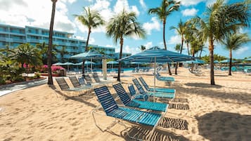 On the beach, white sand, sun-loungers, beach umbrellas