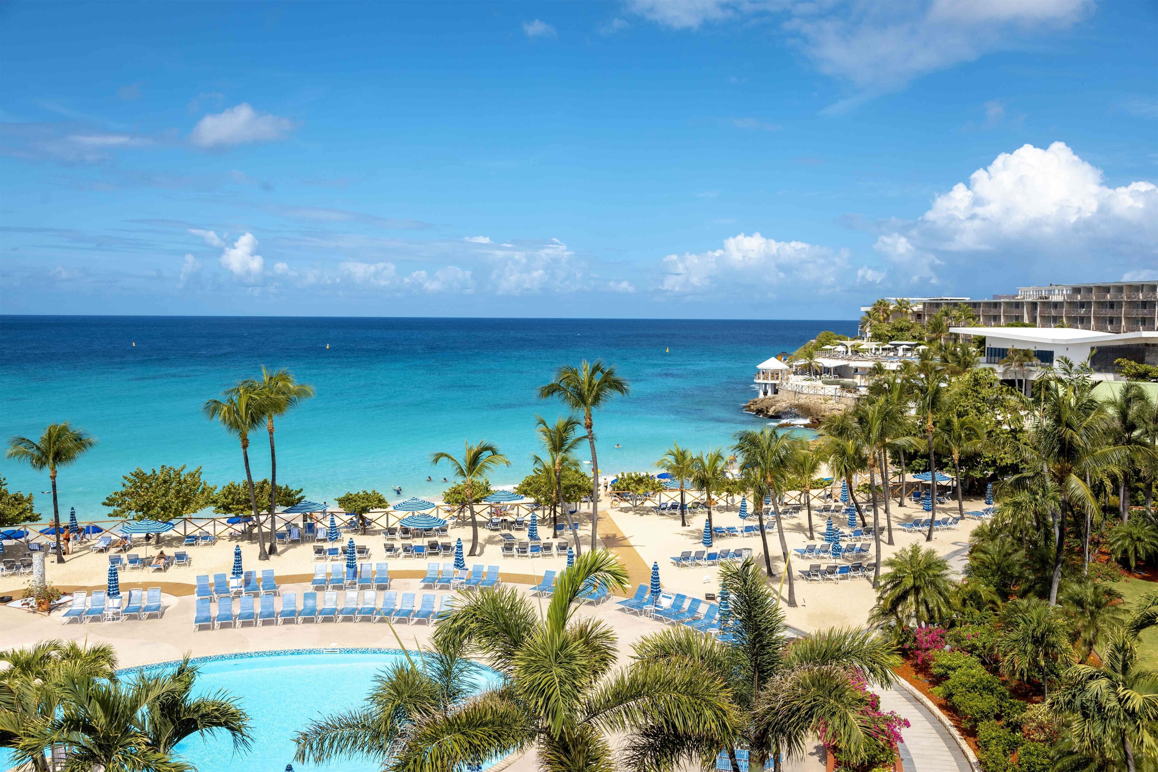On the beach, white sand, sun loungers, beach umbrellas