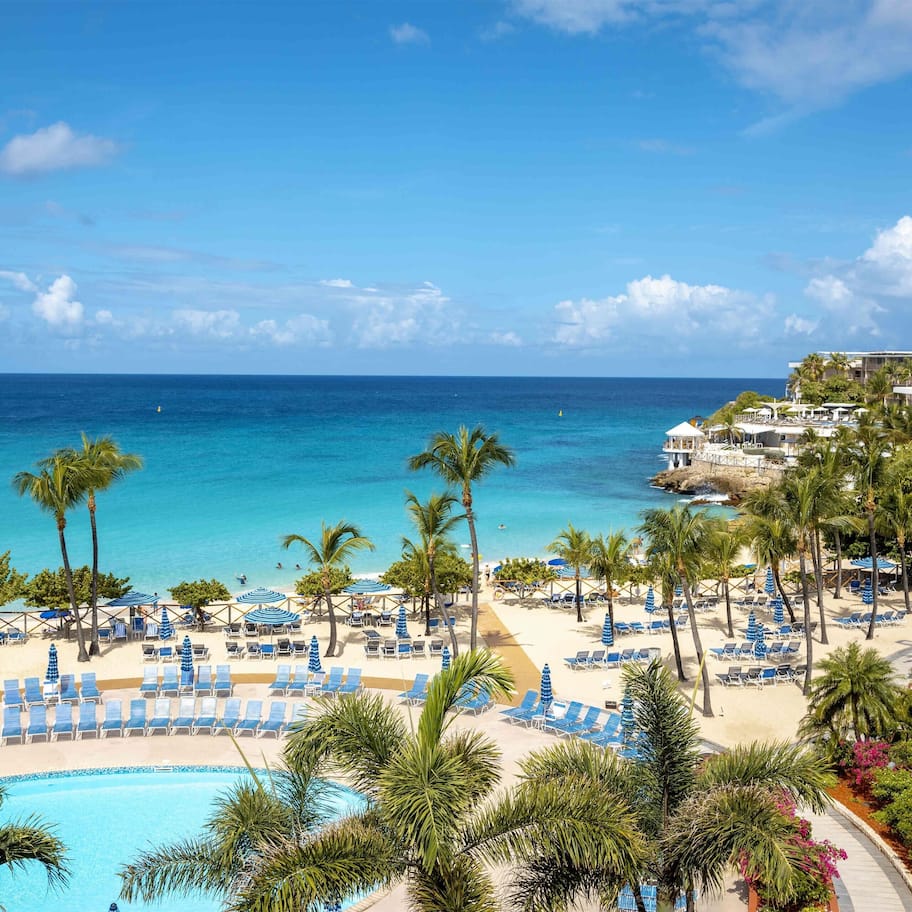 On the beach, white sand, sun loungers, beach umbrellas