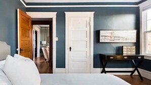 A bedroom with a bed, a desk, and a door. - Walk to Space Needle Vintage View House with King Bed (Seattle)