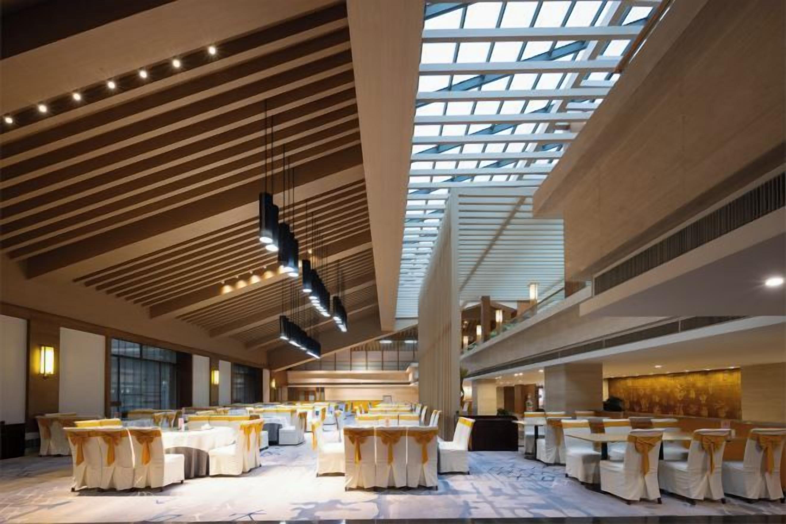 A spacious hall with tiered seating and a high ceiling with skylights.