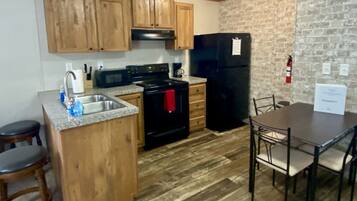 Coffee/tea maker, fridge, cookware/dishes/utensils