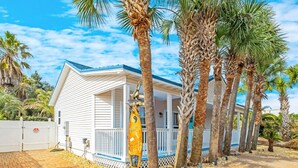 A single-story house with a blue roof and white siding, surrounded by palm trees. - ❤︎Families love the location and private, heated pool❤︎ 6-min walk to beach❤︎ (Destin)