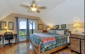 A bedroom with a bed, desk, chair, and a ceiling fan. - Wilkes County Western NC 3br Cottage with Hot Tub! (Boomer)