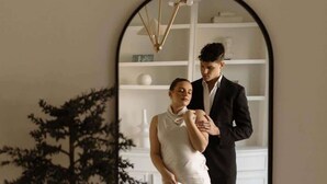 A room with a large mirror reflecting a couple, a small tree decoration, and a geometric patterned floor. - Mr. Nomad: Artistic Abode in Uptown (Dallas)