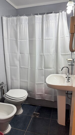 Een haardroger, handdoeken, zeep, toiletpapier