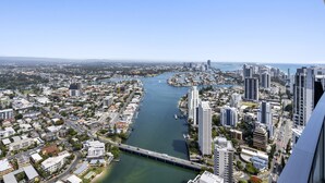 A cityscape with a river, high-rise buildings, and a bridge. - 53rd Floor - Sky High Apartment in Circle on Cavil (Gold Coast)