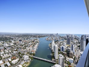 A cityscape with a river, high-rise buildings, and a bridge.