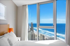 Enjoy ocean and city views from the large window in this stylish room.