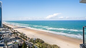 A coastal cityscape with a beach, buildings, and a clear sky. - 28th Floor Oceanfront Bliss in Surfers Paradise (Surfers Paradise)
