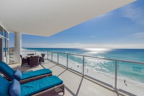 A balcony with wicker furniture and a view of the beach. - VACATION IN PARADISE! ~ Panoramic Gulf Views! Seasonal Beach Service Included! (Destin)
