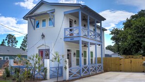 A two-story house with a balcony, a wooden fence, and a number 5409 on the front door.