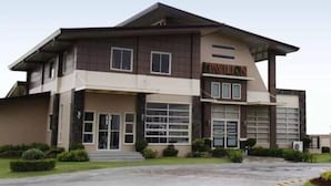A modern building with a flat roof, large windows, and a sign that reads "Pavilion."