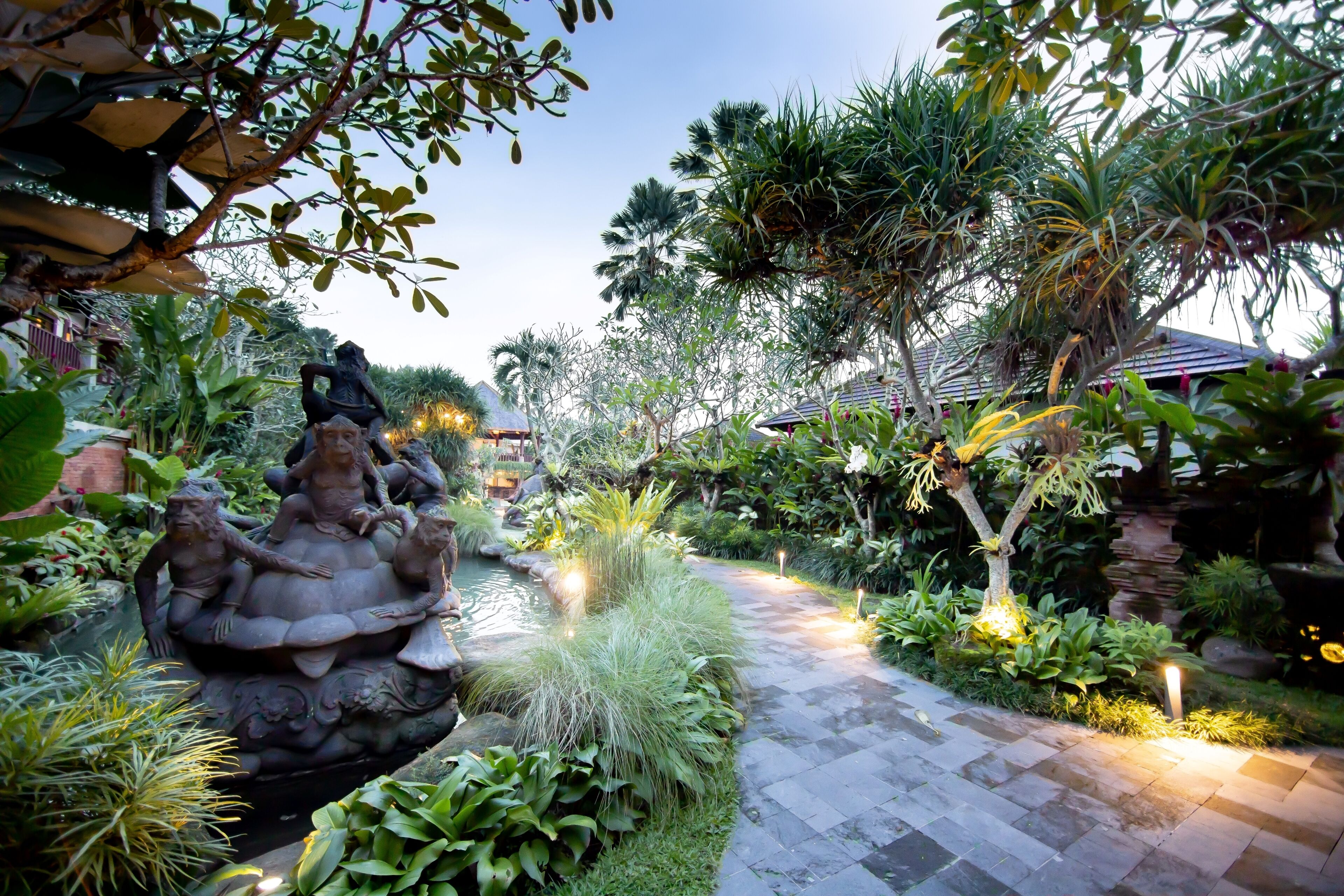 A garden with a water feature and a pathway.