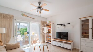A modern living room with a sofa, TV stand, and a ceiling fan. - CostaBlancaDreams - Casa Alis in Calpe (Calpe / Calp)