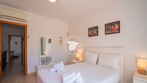 A hotel room with a large bed, a bedside table with a lamp, a mirror, and artwork on the wall. - CostaBlancaDreams - Casa Alis in Calpe (Calpe / Calp)