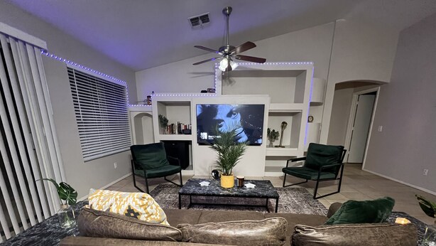 A living room with a sofa, two armchairs, a coffee table, a TV, and a ceiling fan. - Swanky Super Bowl House 2 miles from Stadium. (PHOENIX)