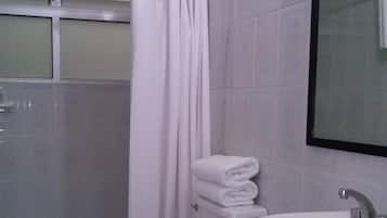 A bathroom with a toilet, sink, and a shower curtain.