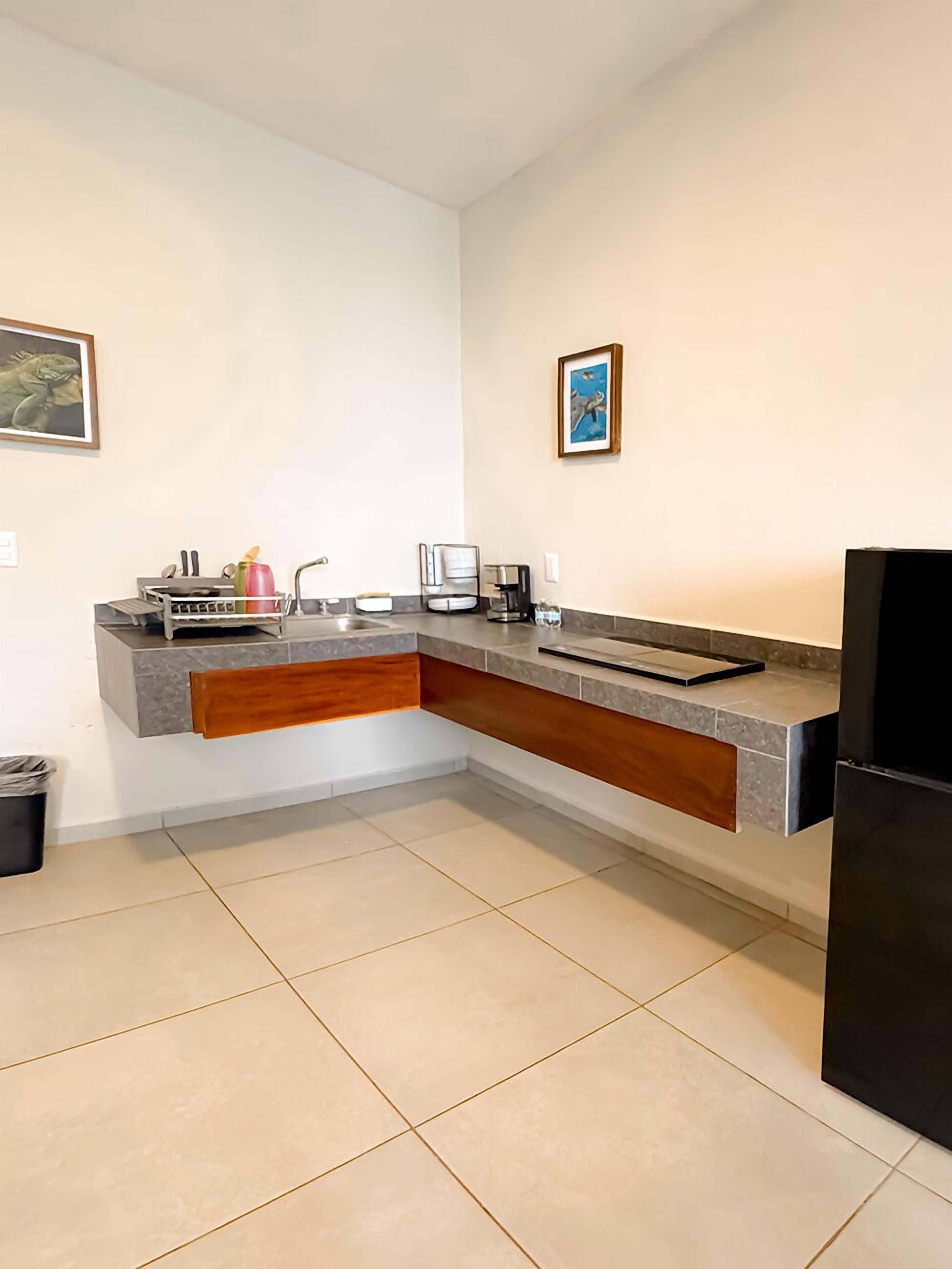 A modern kitchen with a built-in island, a sink, and a refrigerator.