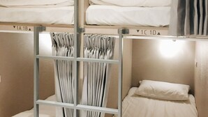 A bunk bed room with two beds, a ladder, and a curtain rail. - Gents House - Hostel (Taipei)