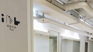 A modern men's restroom with two sinks, mirrors, and a glass partition. - Gents House - Hostel (Taipei)
