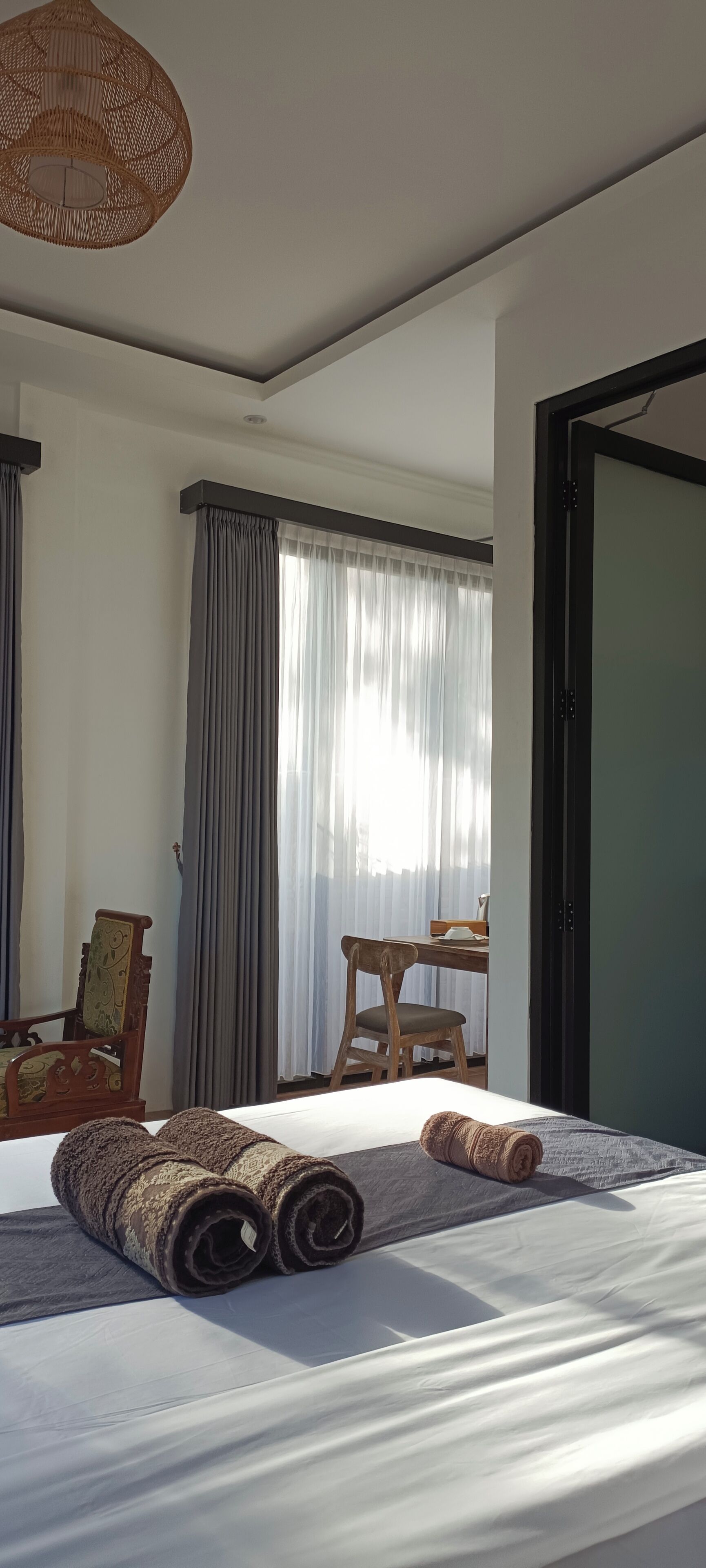 Una habitació d'hotel amb un llit, una taula i una cadira.