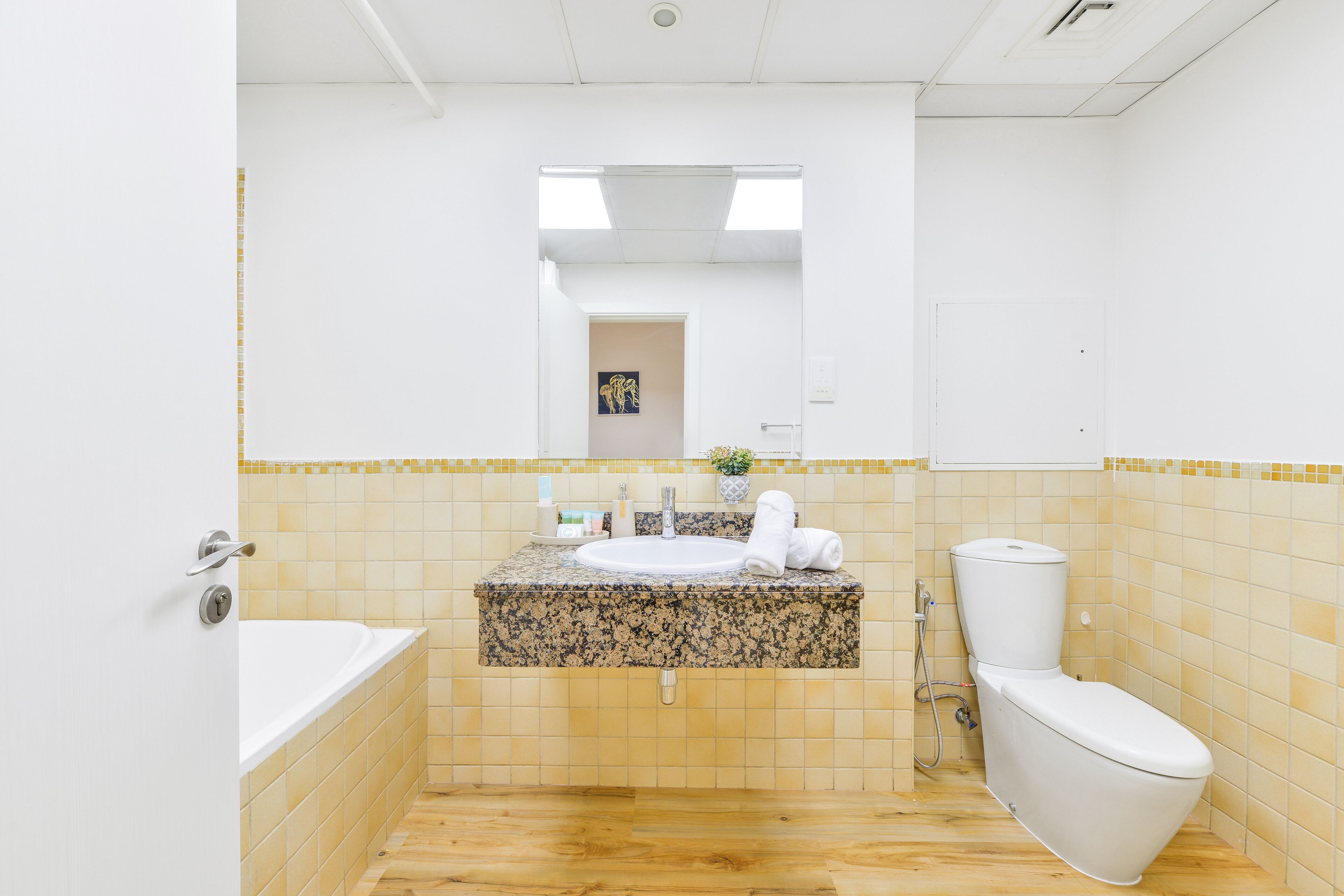 Un baño con lavamanos, inodoro y bañera.