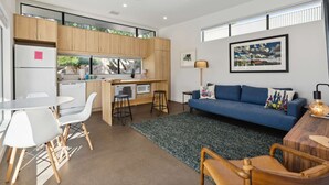 A compact living space with a kitchenette, a dining area, and a seating area with a sofa and chairs. - Refreshing 2-bedroom Container - 80 Walkscore! (Phoenix)