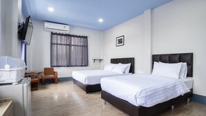 A hotel room with two beds, a TV, an air conditioner, and a wooden chair. - Udomsuk Hotel (Satun)