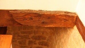 A wooden staircase with stone walls.